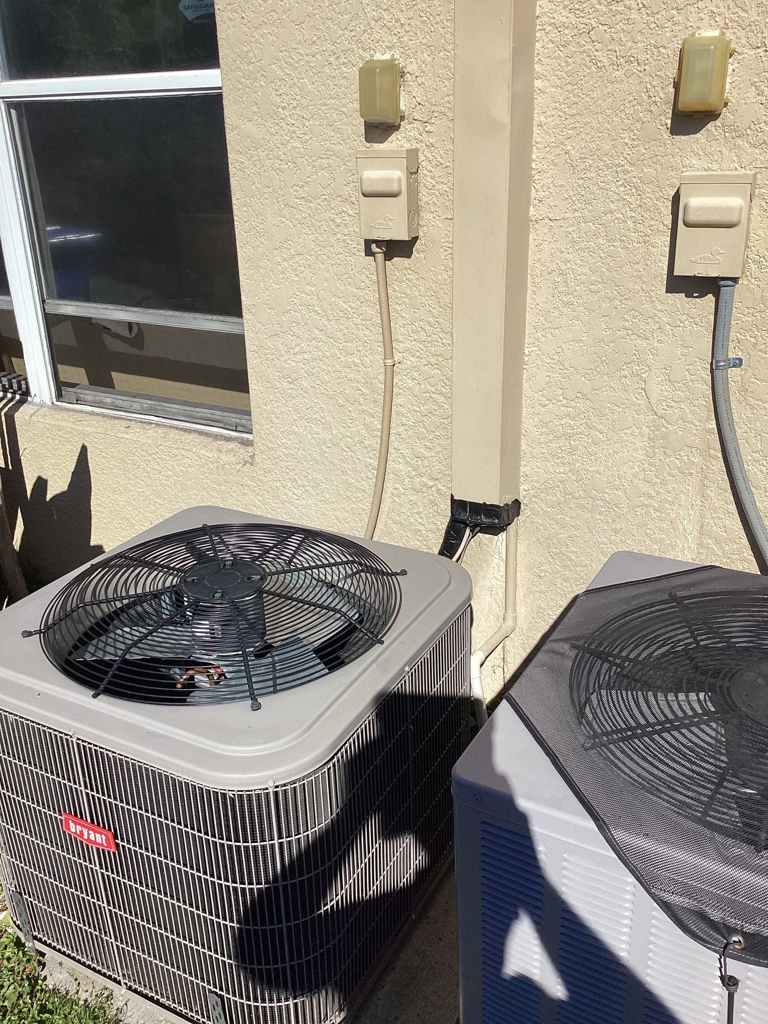 Relocated AC condenser on its new pad beside the second unit in Riverview, FL