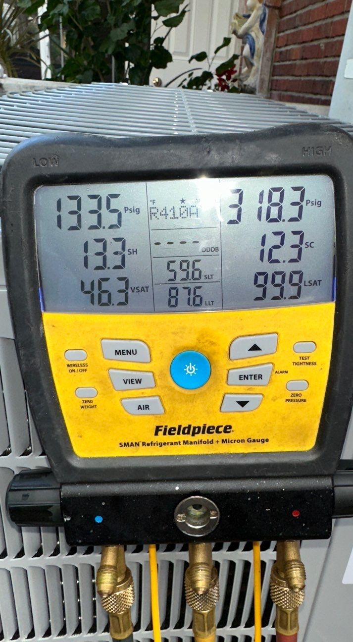 Digital refrigerant gauge readings on a newly installed heat pump