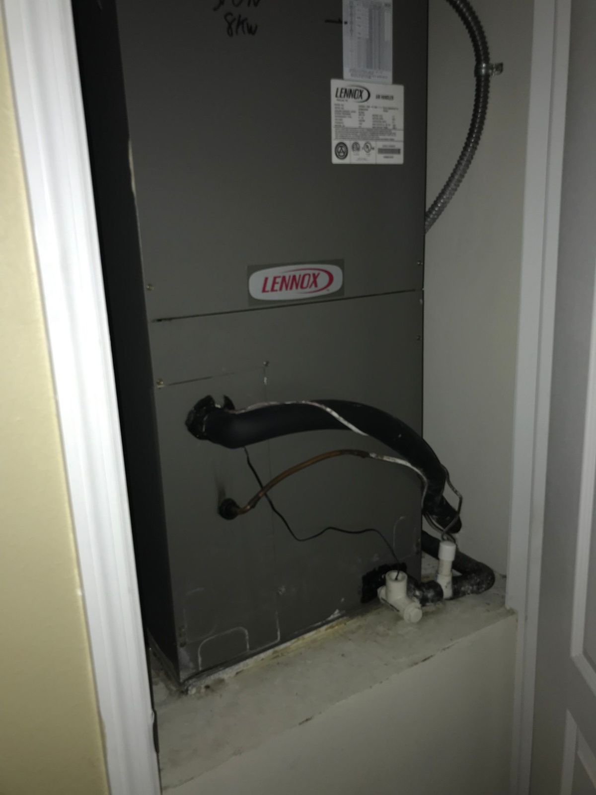 Old vertical air handler in an interior closet before replacement