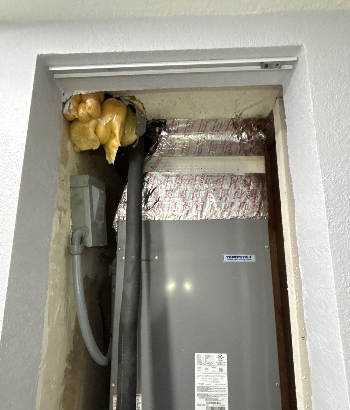 Closet air handler during duct replacement in Lutz, FL