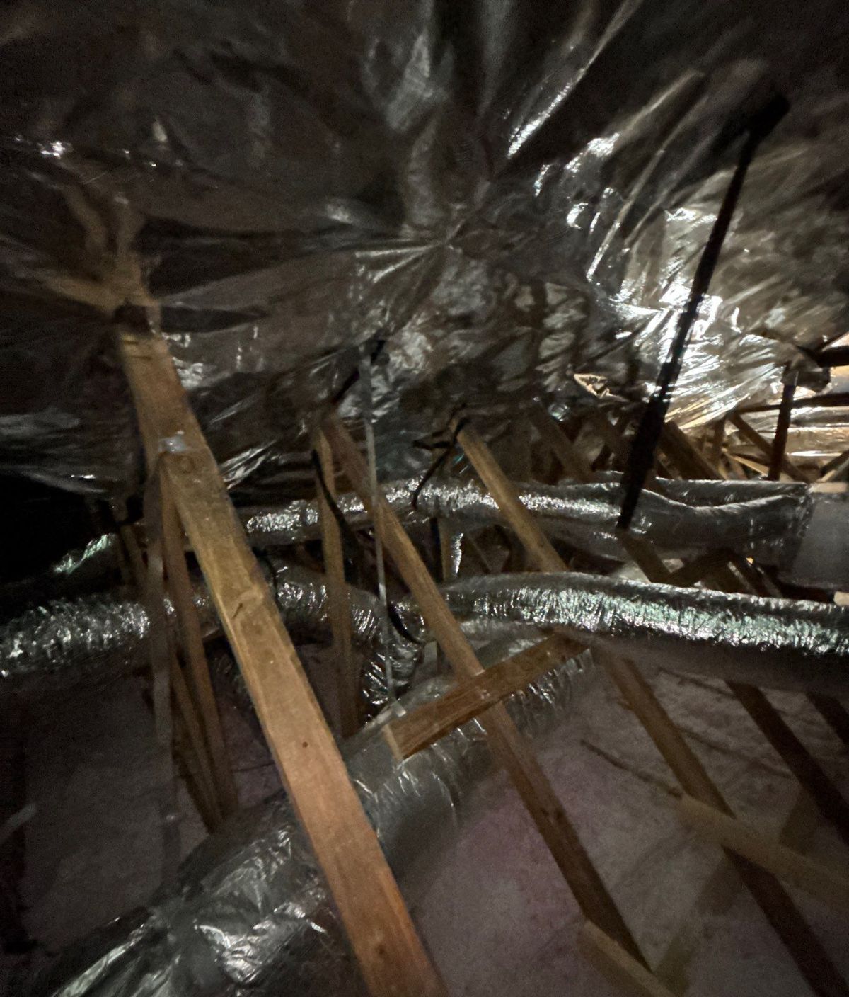 Finished flex duct runs across the attic after a full supply duct replacement