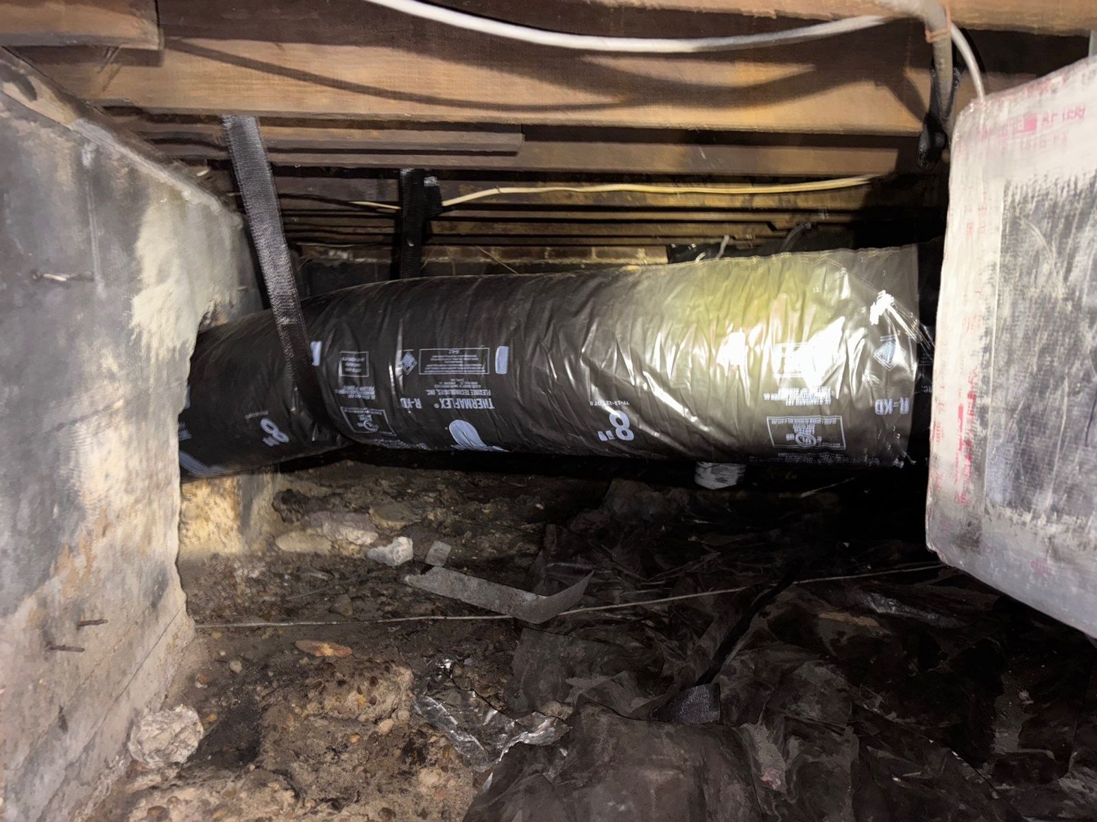 New R4 insulated duct run supported under the floor of a South Tampa home
