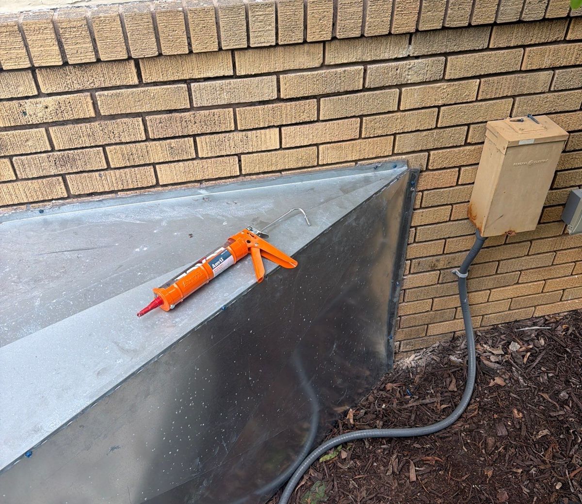 Exterior duct plenum sealed along the brick wall of a South Tampa home