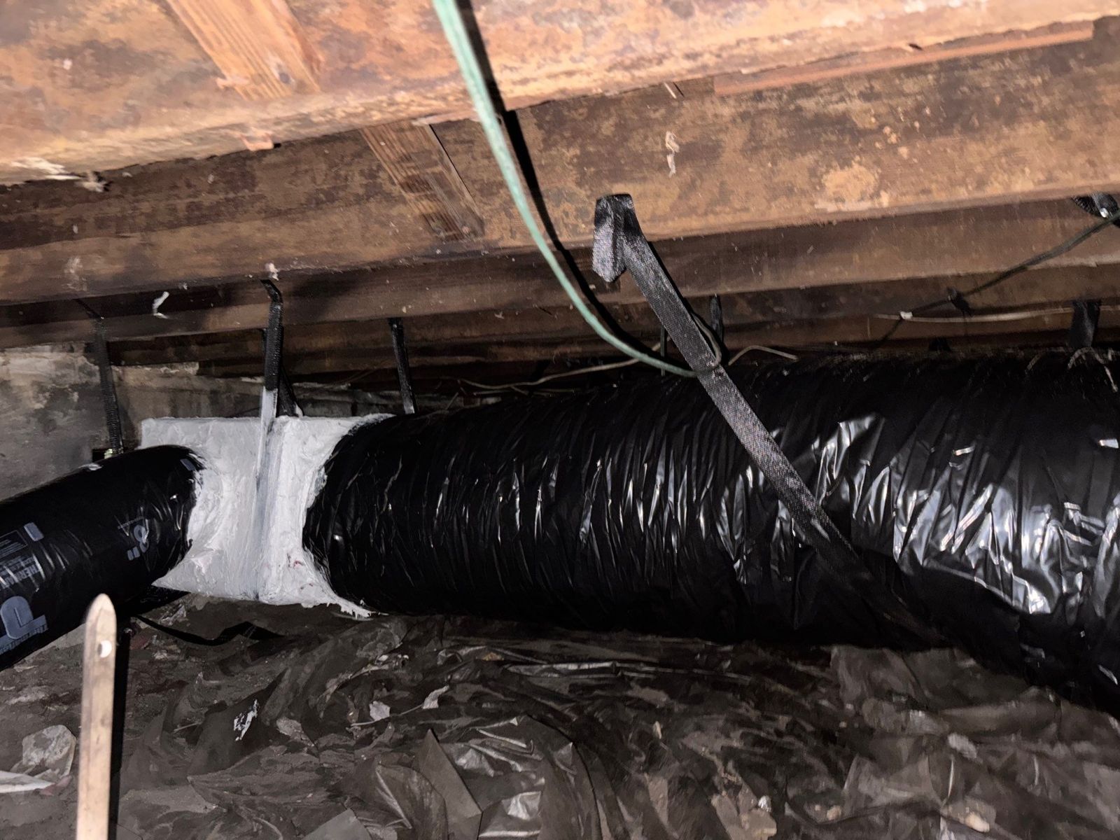 New flex duct strapped to the floor framing in a South Tampa crawlspace