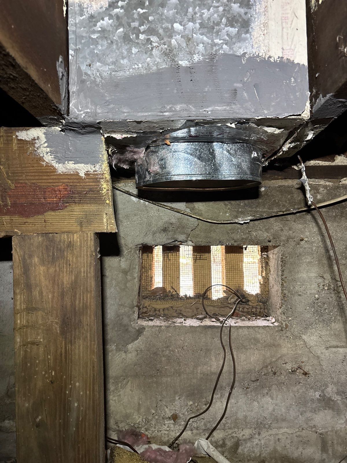 New duct collar installed at a sheet metal plenum in a crawlspace