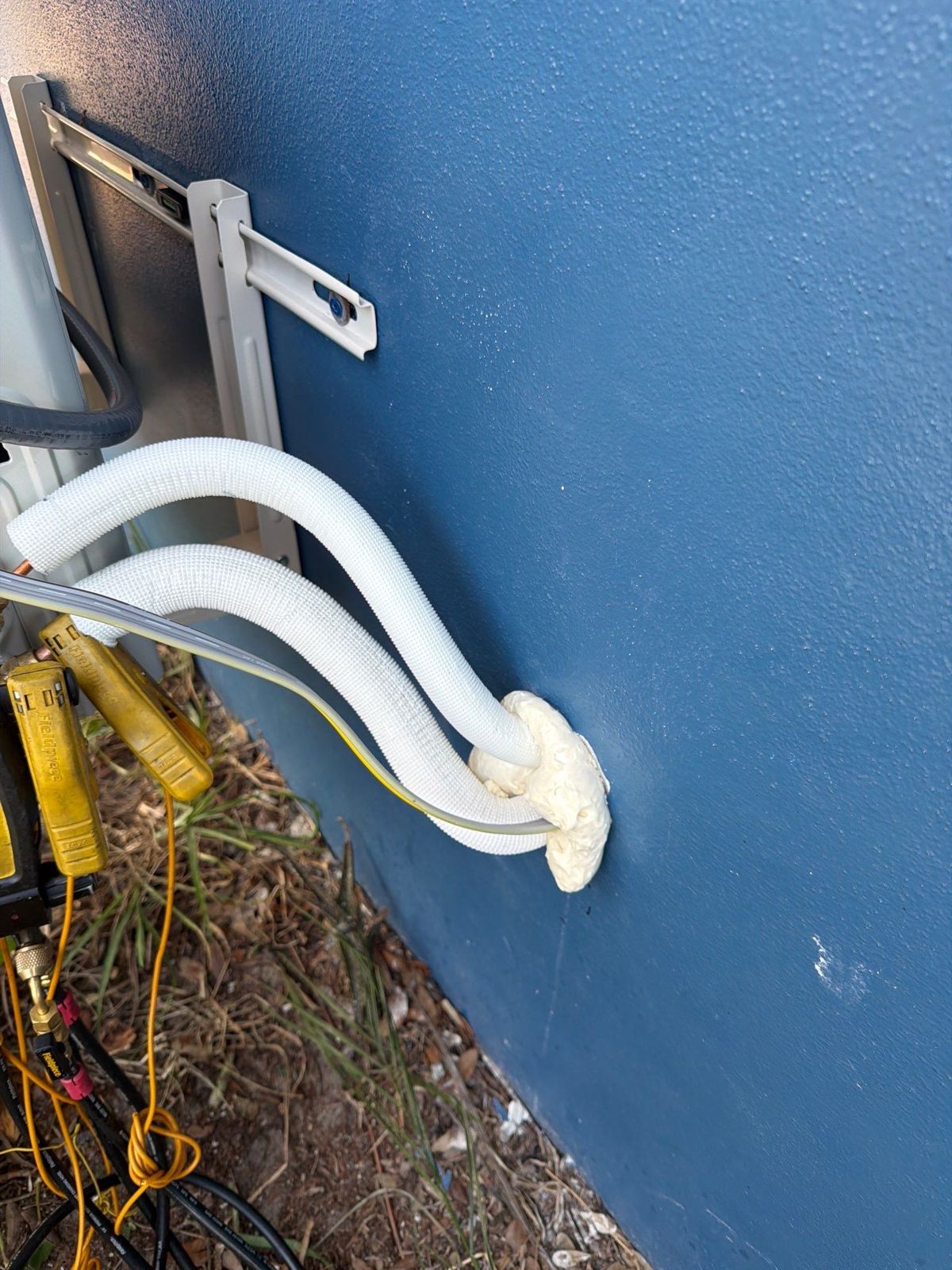 New insulated mini-split line set entering the exterior wall