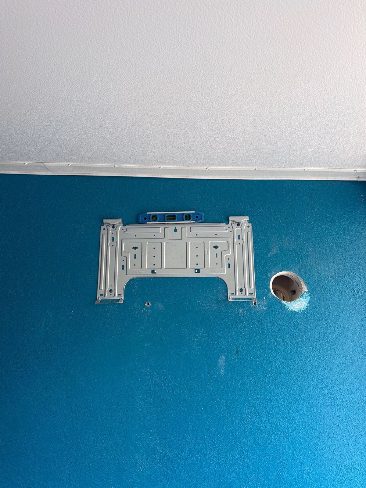 New mini-split wall bracket mounted next to the line set penetration
