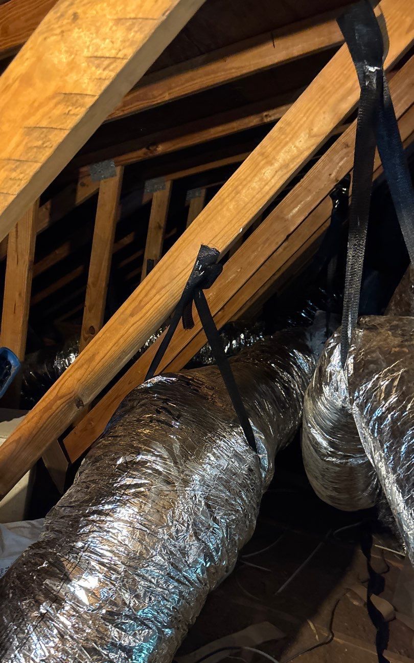 New flex ducts hung on straps across the attic