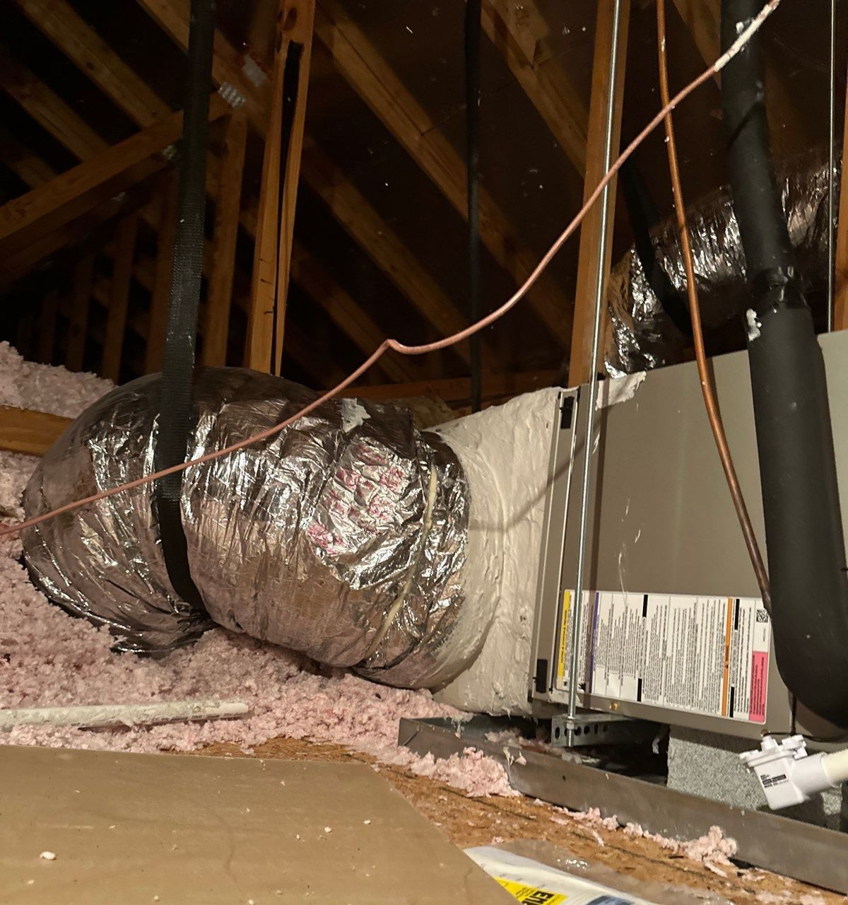 New air handler with insulated ducts on the attic platform