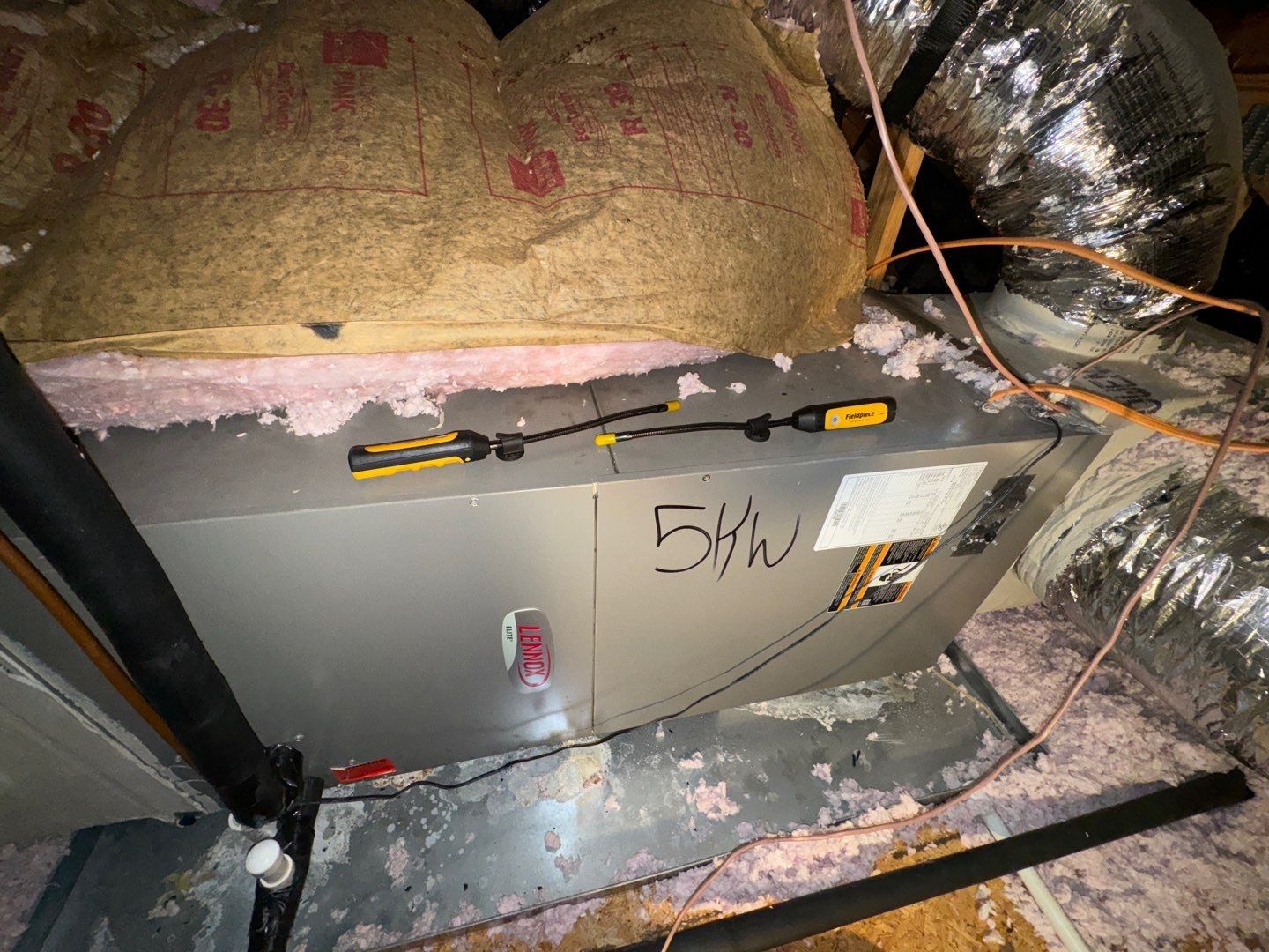 Old horizontal air handler on an attic platform before replacement