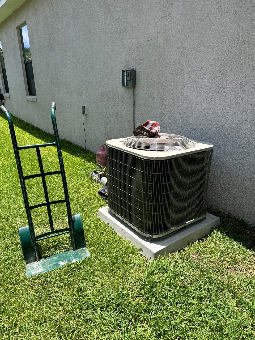 New heat pump outdoor unit set on a new pad in Auburndale, FL