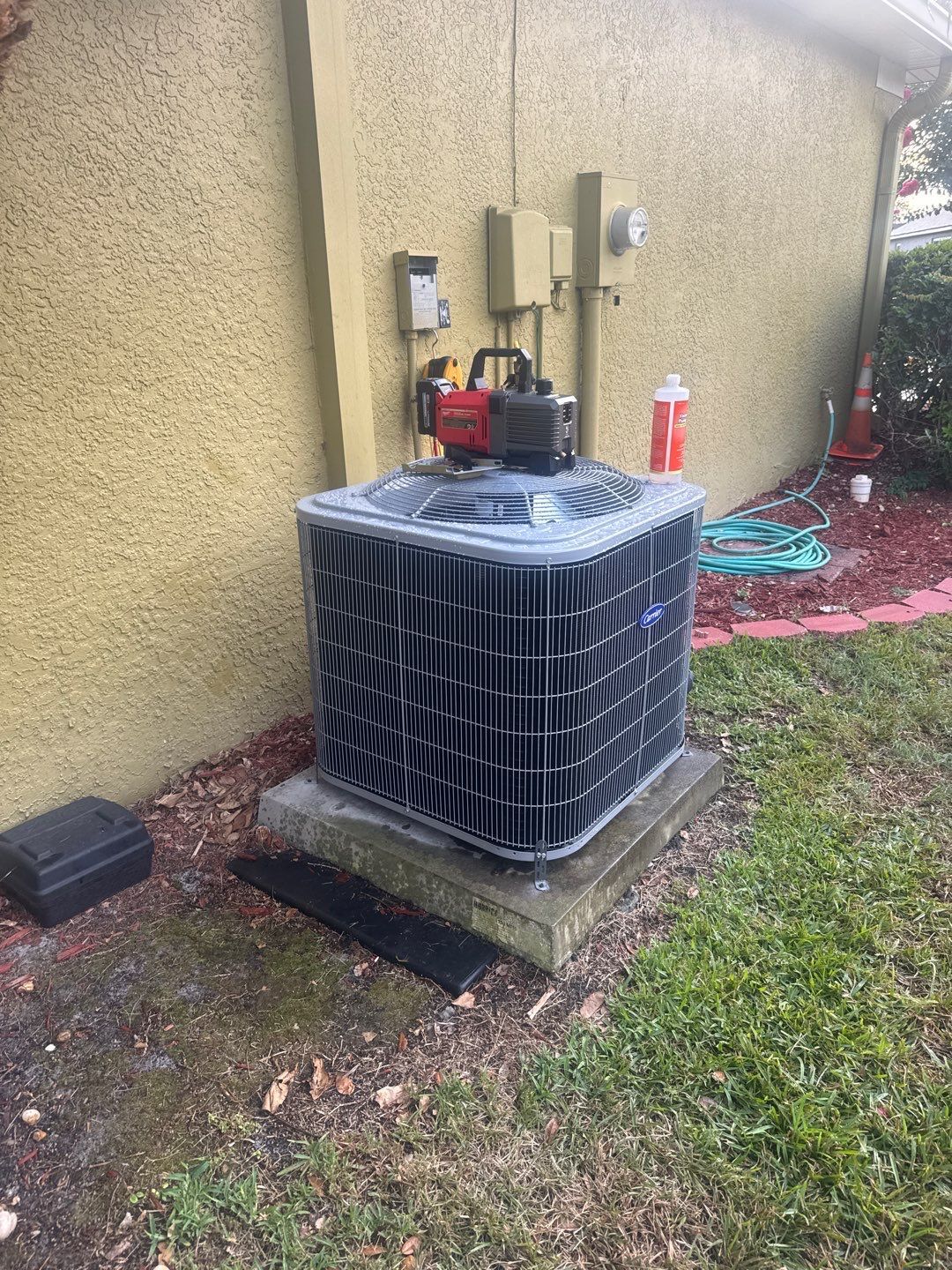 New heat pump outdoor unit set on the pad during installation
