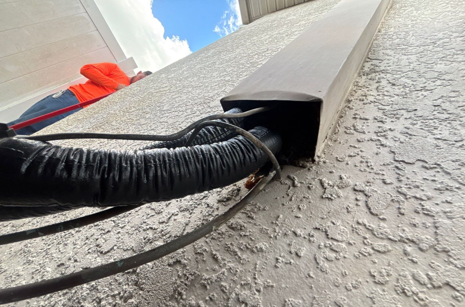 Line set routed into a cover along the exterior wall after heat pump installation