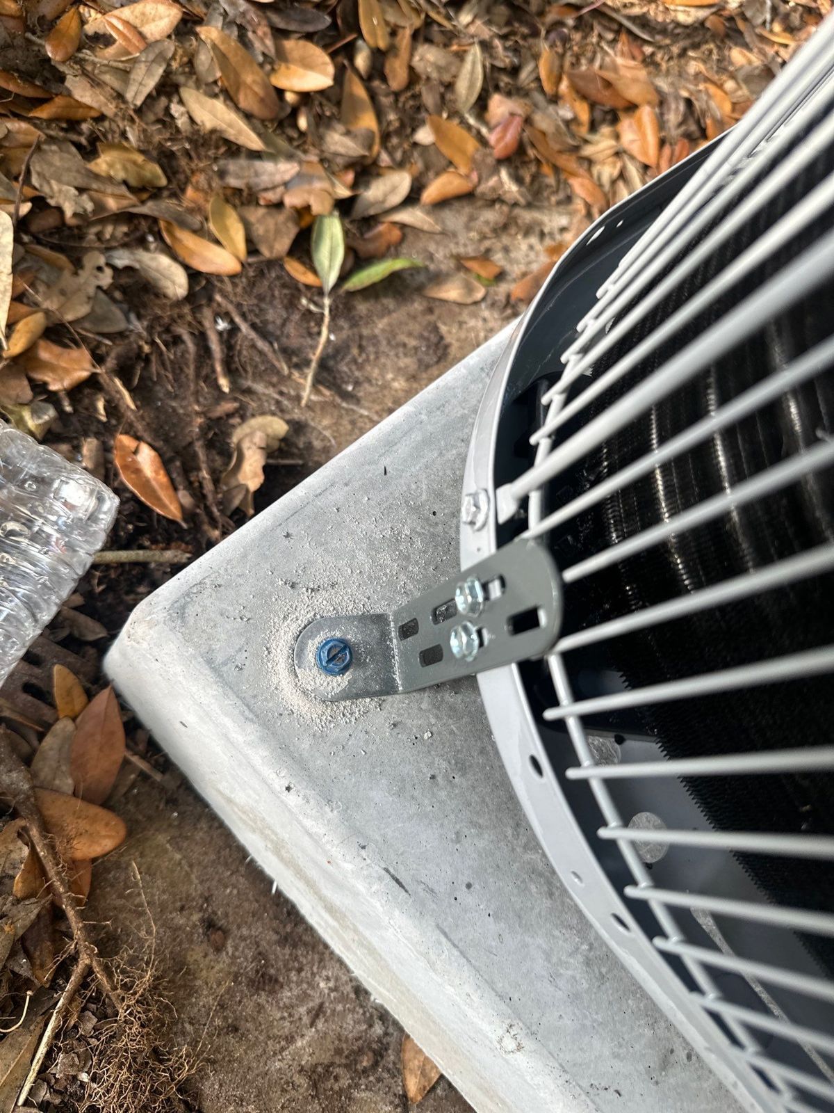 New heat pump outdoor unit bracketed to a hurricane pad
