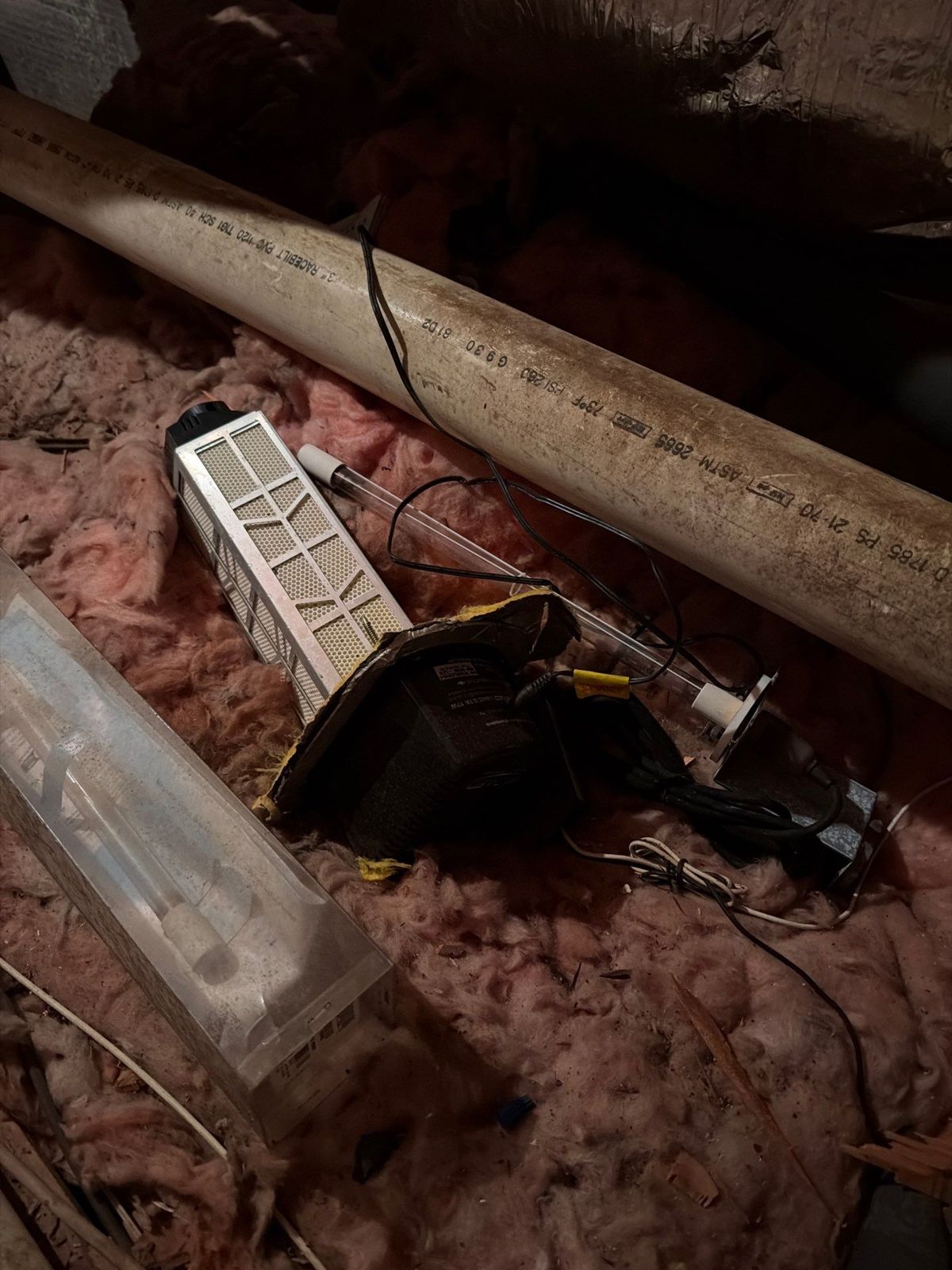 Old equipment being removed from an attic during heat pump replacement