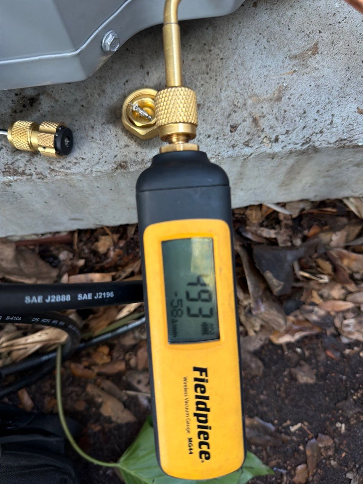 Micron vacuum gauge on the line set during heat pump installation