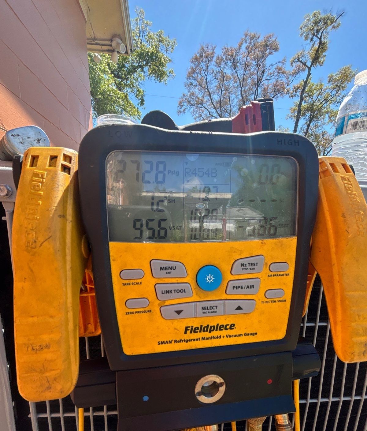 Digital refrigerant gauges connected to a new heat pump in Tampa